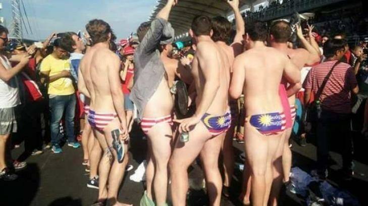Nine Australians, including Jack Walker, a staffer to minister Christopher Pyne, (also wearing a grey shirt) were arrested in Malaysia after stripping to show off Malaysian flag underwear. Photo: Facebook