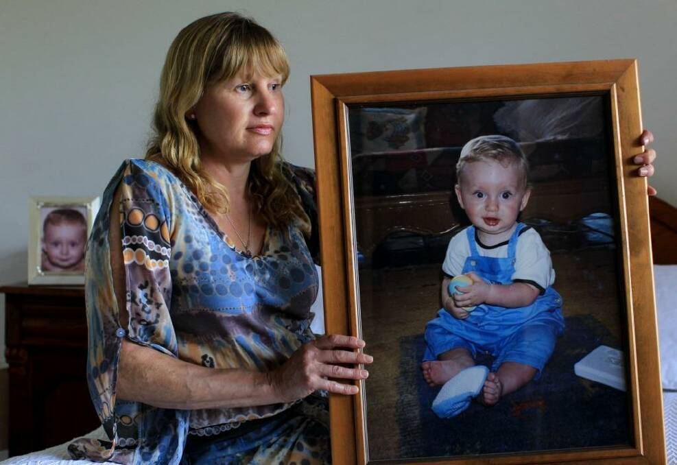 Sorely missed: Sue Steele holds a portrait of her son, Scott, who was killed in a car accident in Dee Why. Photo: Janie Barrett