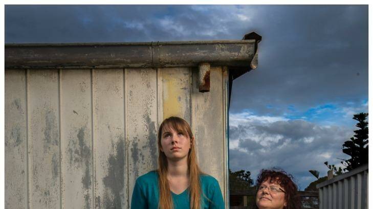 Photograph Simon O'Dwyer. The Age Newspaper. 240415. Bernadette with her daughter Tahlia (green top) who have both had to relocate because their husband/father was very abusive. Photograph taken in their backyard in Melbourne. Photo: Simon_O'Dwyer