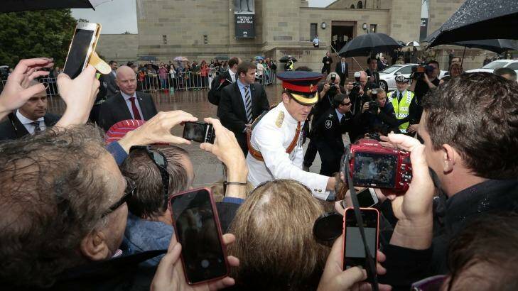 Prince Harry meets the crowd who braved wet weather outside the Australian War Memorial. Photo: Jeffrey Chan