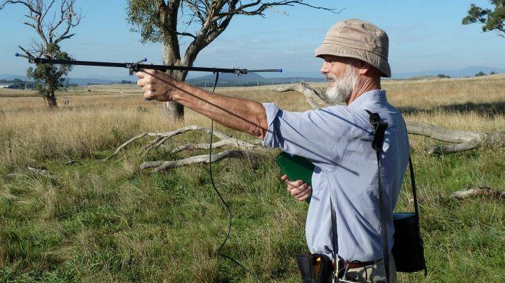 Professor George Wilson, seen here retrieving GPS collars used to track kangaroos in the ACT, says farmers need to have an interest in safeguarding kangaroos. Photo: Australian Wildlife Services