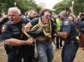 Hundreds of police clashed with protesters at the University of Texas at Austin. (AP PHOTO)