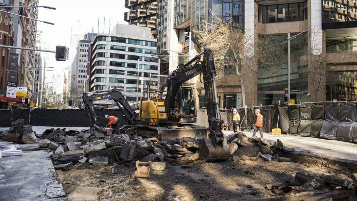 Diggers rip up roadway on the intersection of George, Bridge and Grosvenor streets in Sydney's CBD on Saturday. Photo: Dominic Lorrimer