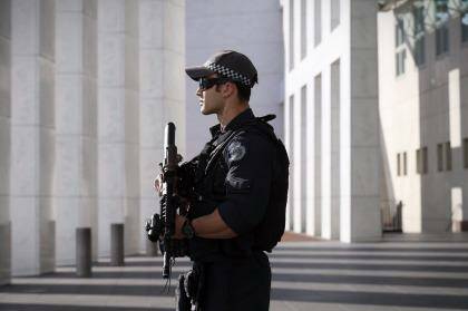 An AFP officer armed with an SR-16 stands guard to the front of Parliament House in Canberra in October.  Photo: Andrew Meares