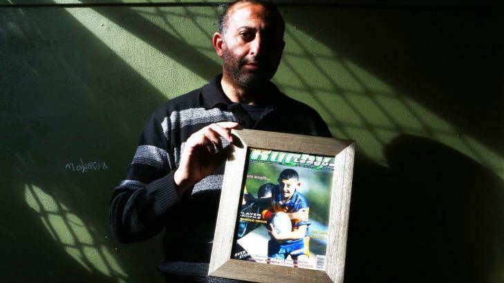 Grieving father: Azzam Hrouk with a picture of his son Mahmoud. Photo: Daniel Munoz