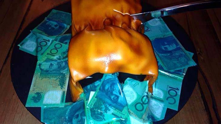 The birthday cake showing a paper bag overflowing with money, which Jeff McCloy has apologised for.