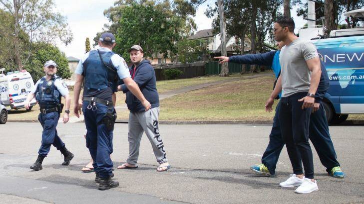 Relatives clash with police and media at the scene of Tuesday's fatal shooting in Georges Hall. Photo: Fairfax Media