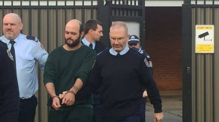 Marcus Stanford is escorted into Leeton court on Tuesday morning. Photo: Emma Partridge