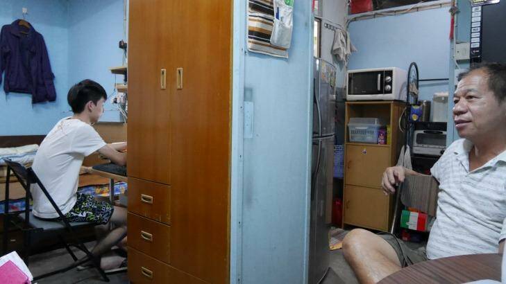 Generation gap: Dasher Mak and his father in their rooftop flat in Sham Shui Po. Photo: Philip Wen