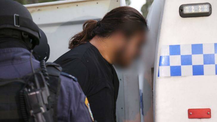 Police arrest a man after terrorism raids in Wentworthville. Photo: NSW Police