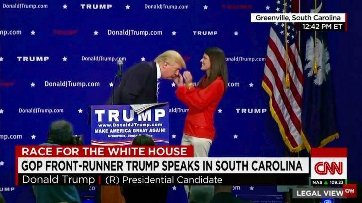 Donald Trump allows an unidentified audience member at his South Carolina press conference to inspect his hair. Photo: YouTube