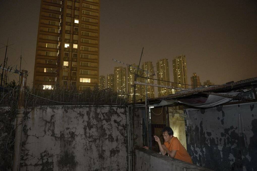 Construction worker Wong Man-chung smoking in front of his rooftop home. Photo: Urban Anderson