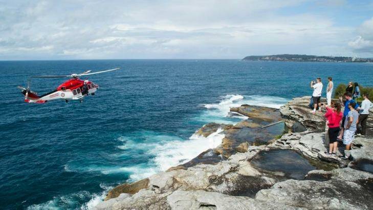 A rescue helicopter attends the scene where a rock fisherman died on the northern beaches.  Photo: Surf2summit