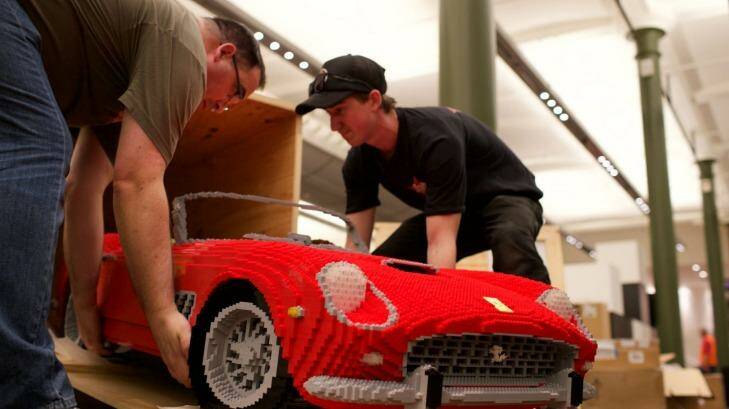 Professional Lego builder Ryan McNaught, left, with his bright red Ferrari.  Photo: Wolter Peeters