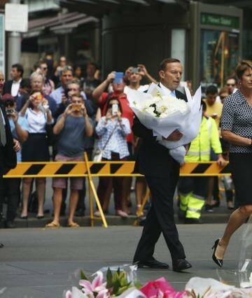 Prime Minister Tony Abbott and his wife Margie pay their respects to the victims of the Martin Place siege. Photo: Steve Christo