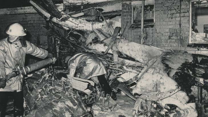 The plane wreckage wedged against the home of Giuseppe and Angela Corrso. Mrs Corrso suffered slight burns while their two children escaped injury.  Photo: John Krutop