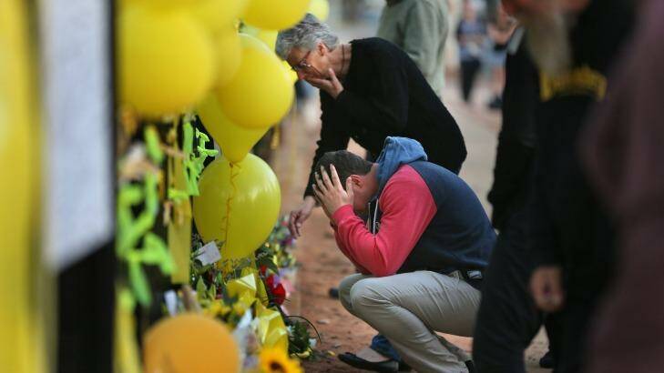 Stephanie Scott's mother Merrilyn and fiance Aaron Leeson-Woolley at the floral memorial on the gates of the Leeton High School last year. Photo: Kate Geraghty