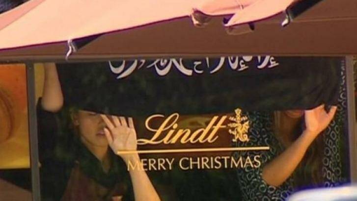 Hostages were earlier seen holding an Islamic flag that is not the Islamic State flag against the window of the Lindt Chocolat Cafe in Martin Place.