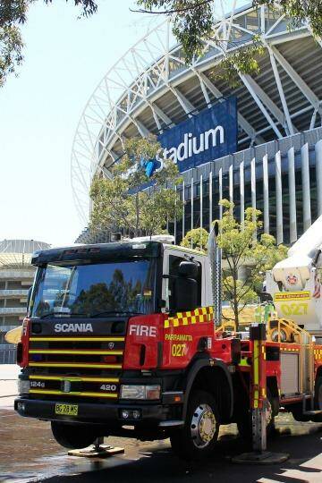 Firefighters perform a routine training exercise against a chemical or powder attack at ANZ Stadium on Thursday afternoon. Photo: Daniel Munoz