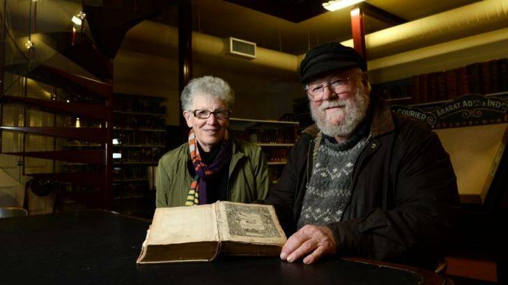 Volunteer Marion Blythman and Roger Burrows with the 1585 Breeches Bible. Photo: Ballarat Courier