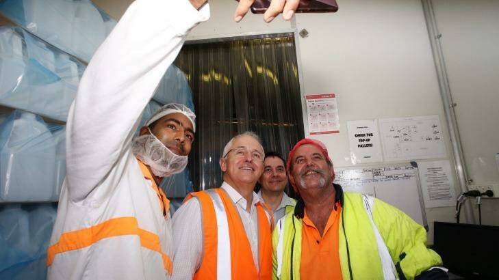 Prime Minister Malcolm Turnbull poses for a selfie with workers at  Grove Fruit Juice in Brisbane. Photo: Andrew Meares