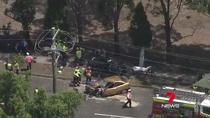 Emergency services at the scene of a car crash at Cabramatta  in which a woman died on Wednesday.  Photo: Seven News Sydney