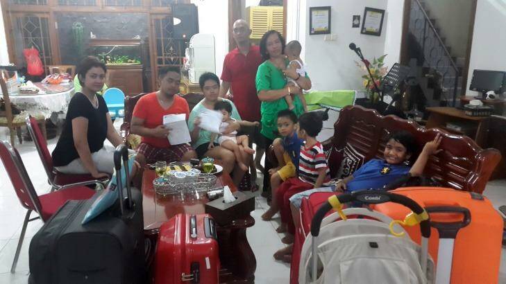 Lucky escape: Christianawati, her husband Ari Putro Cahyono and their extended family after missing their doomed flight QZ8501. Photo: Supplied