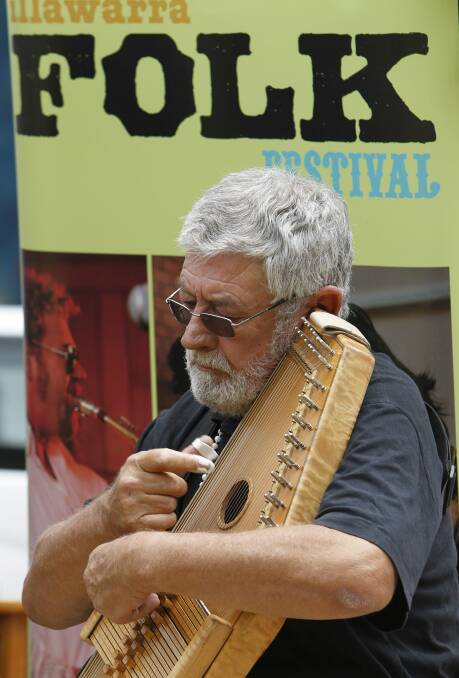 Talented auto harp musician Denis McKay plays at the launch of the Illawarra Folk Festival, to be held at Bulli Showground, January 15-18. Picture: ANDY ZAKELI