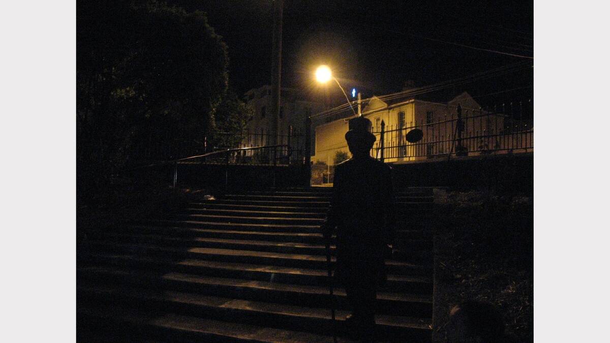 An eerie streetlamp behind the statue of William Russ Pugh in Prince's Square, a stop on the Launceston City Ghost Tour. 