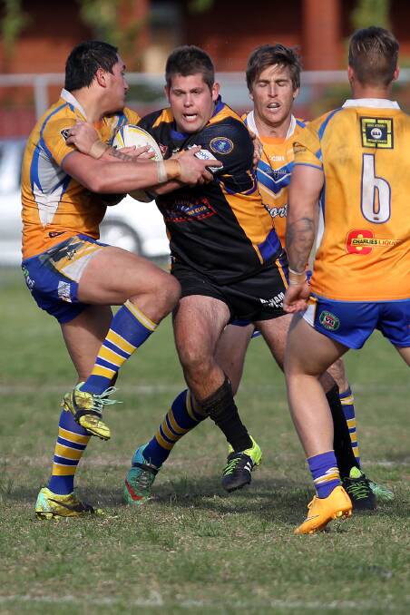 LEADER: Jets' forward John Carey brushes off a couple of would be Warilla defenders on Sunday.