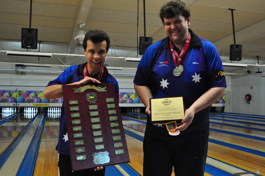 KNOCKING THEM DOWN: Steven Lucre and Glenn Corbett show off their awards from recent Australian Disabilities Tenpin Bowling Championships. Photo: COURTNEY WARD