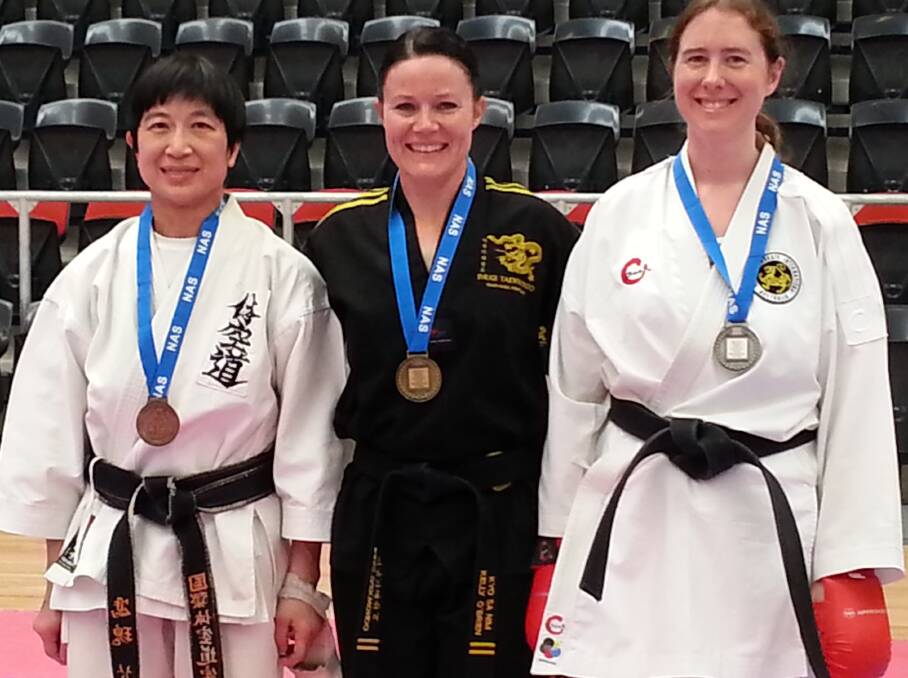 SILVER LINING: Amanda Baker (right) poses with her silver medal, which she won in the women’s open points sparring.