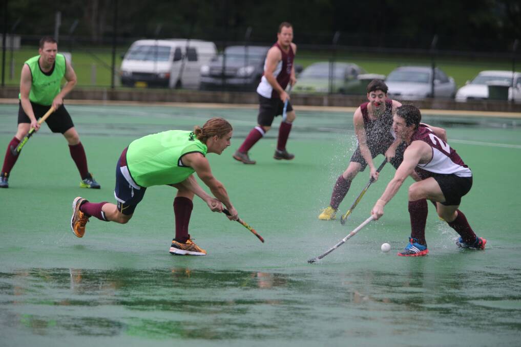 IN THE FACE: Kangaroo Valley Mountain Men’s James Hayes flicks the ball and water in the direction of opponent Brendon Gilmore. Photo: ROBERT CRAWFORD