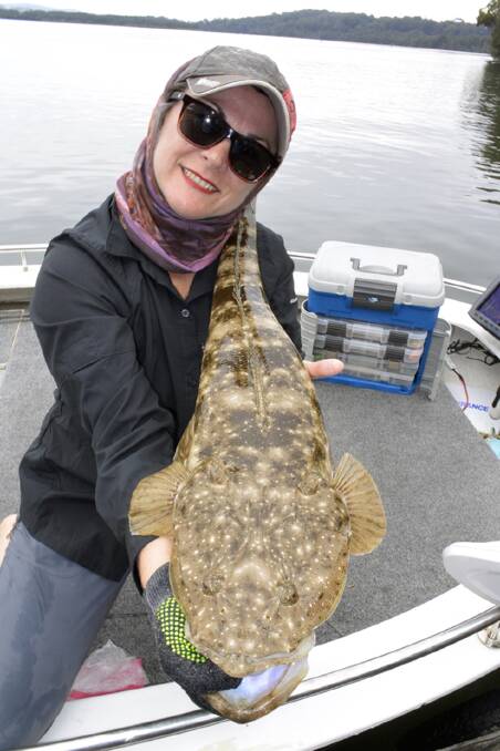 BIG CATCH: Jo Starling shows off her 84cm flathead caught using a squidgy pro prawn 100mm. Photo: STEVE STARLING