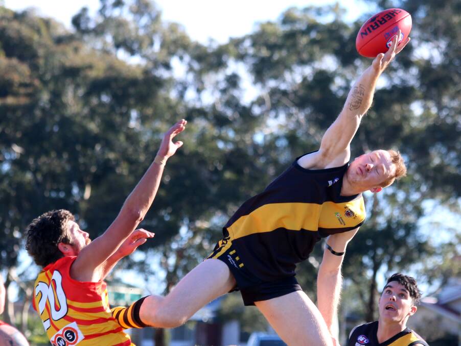 BALANCE: Tigers Brent Herdman taps the ball to a team mate in a contest at Artie Smith Oval. Photo: CATHY RUSSELL.