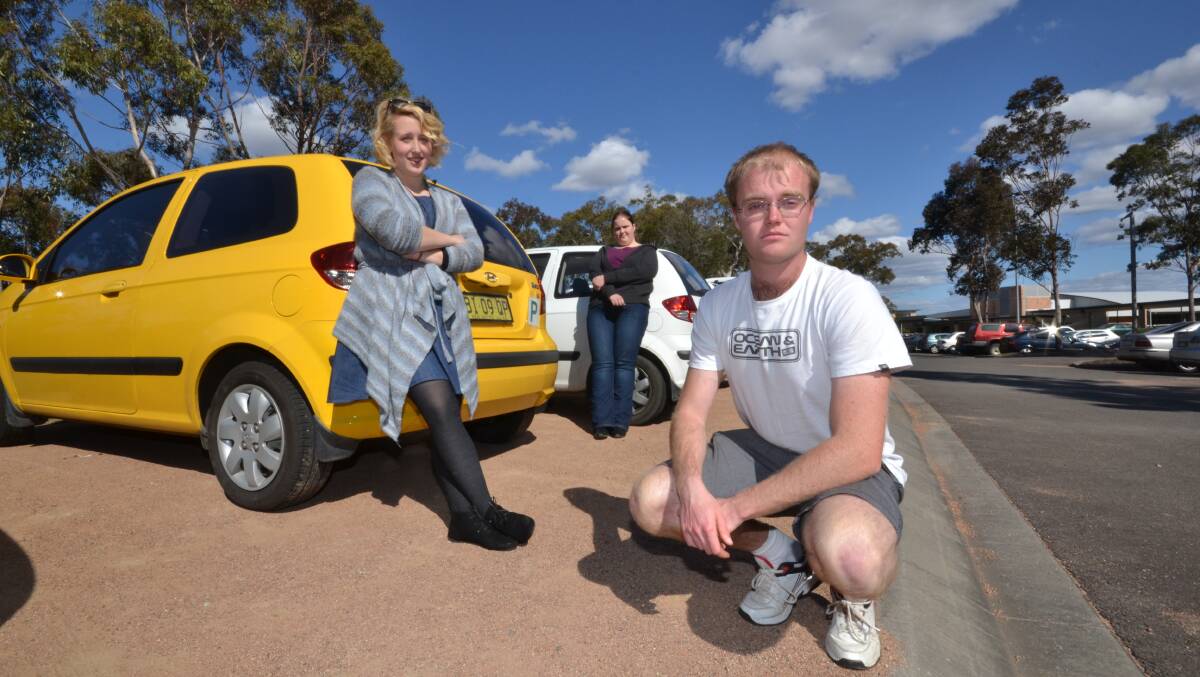 NOT IMPRESSED: University students Amelia Smith, Robyn Carpenter and Tim May consider themselves poor people who do drive a lot.