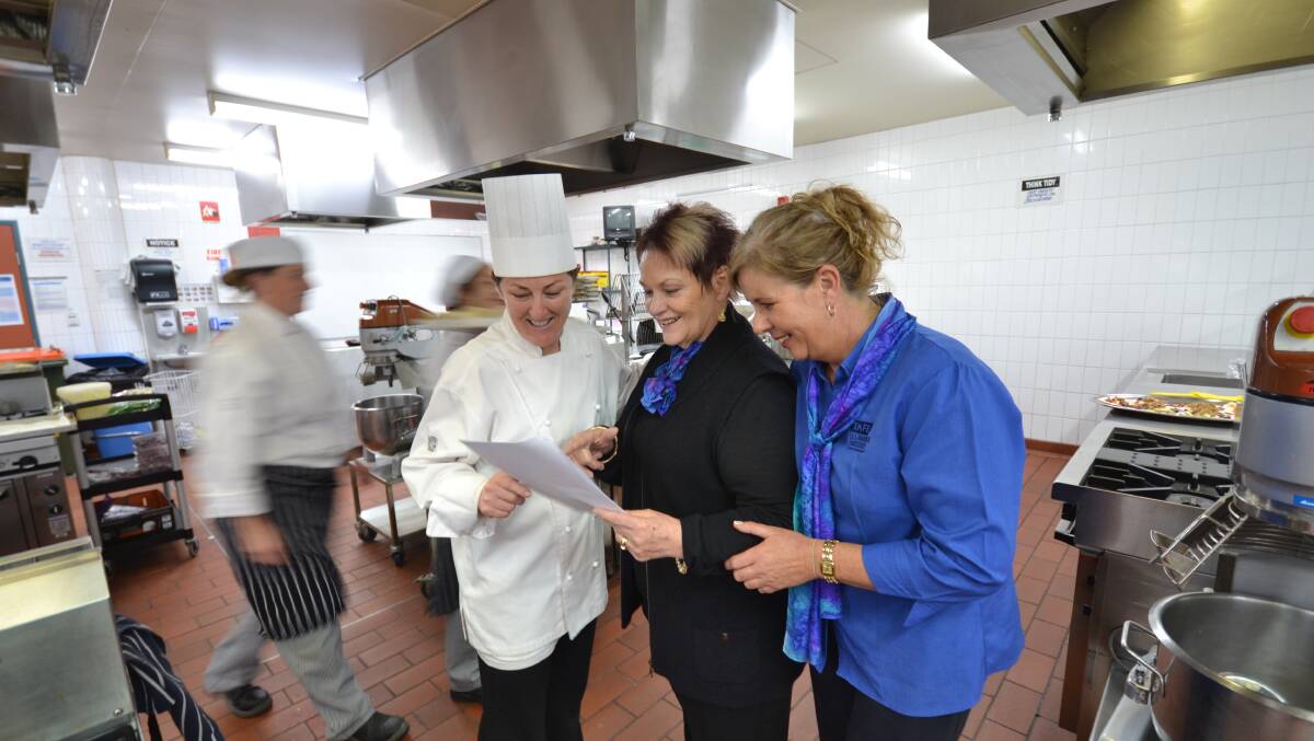 PRESSURE COOKER: Jo McRae, Di Laver and Helen Mairinger in action backstage during this year’s celebrity chef preparation.