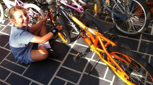 Tia fixing up bike at her home. Photo: supplied