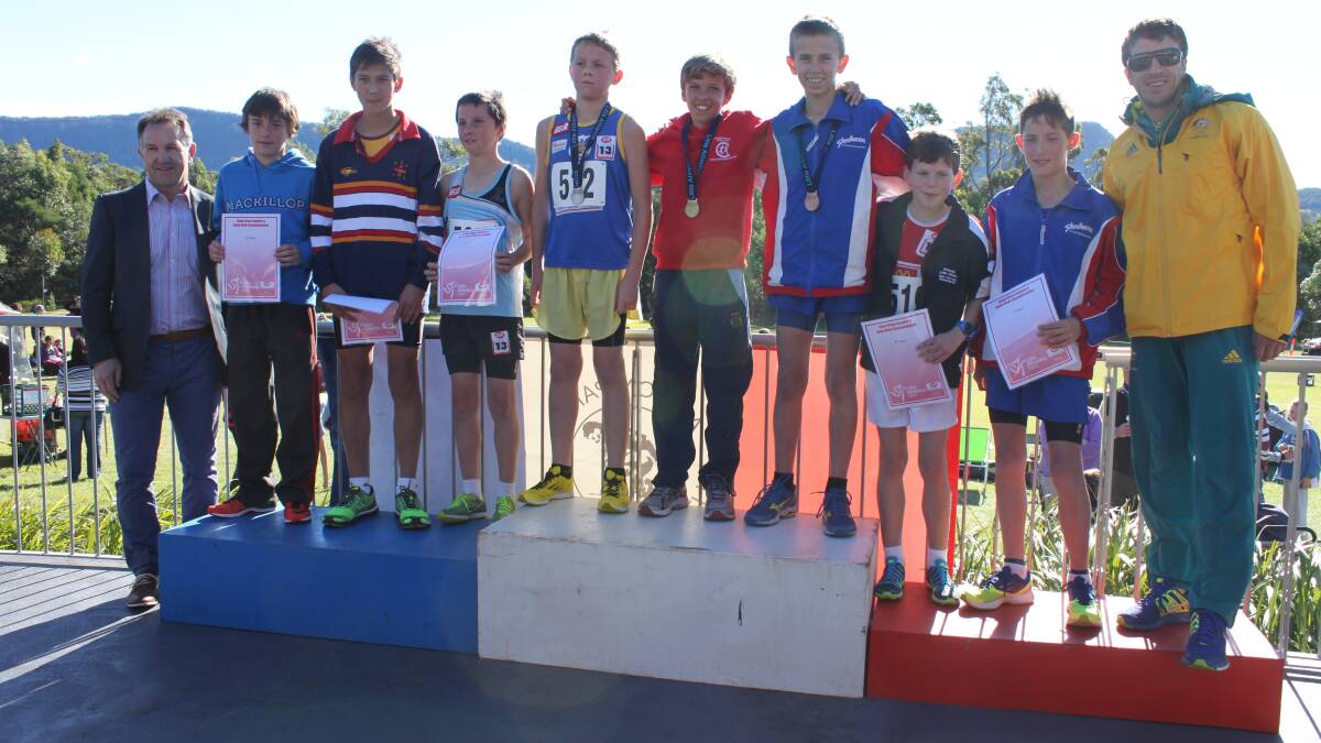 PODIUM MOMENT: Shoalhaven athletes Hugh Dobson and Jesse Buckham join the top eight finishers in the under 13s with Olympian Youcef Abdi. 