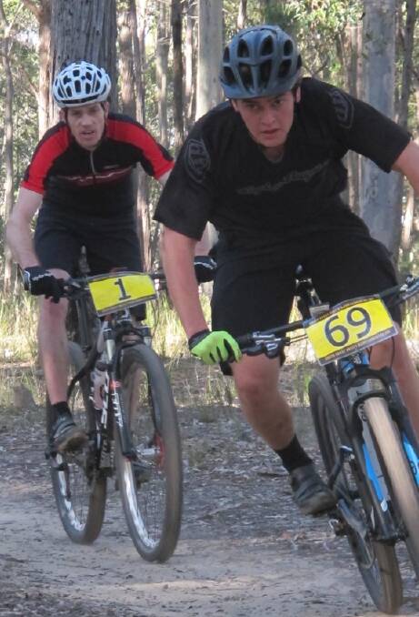 WHEEL TO WHEEL: David Bell and Rhyse Flahive in action at the last round of the South Coast United Mountain Bike Club Cross Country Championships. 
