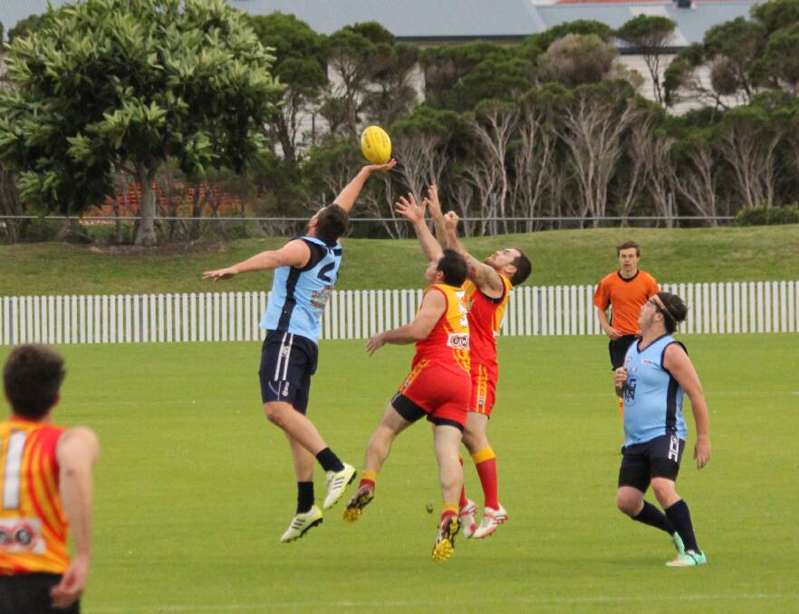 HIGH ACTION: Nowra Blues players Liam Walsh jumps up to mark the ball with Dylan Spressor in support. 