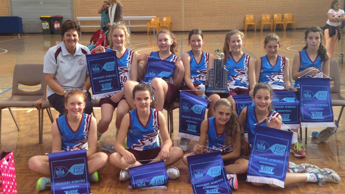 TEAMWORK: The MacKillop girl’s basketball team celebrate their win in the NSW PSSA championships. 