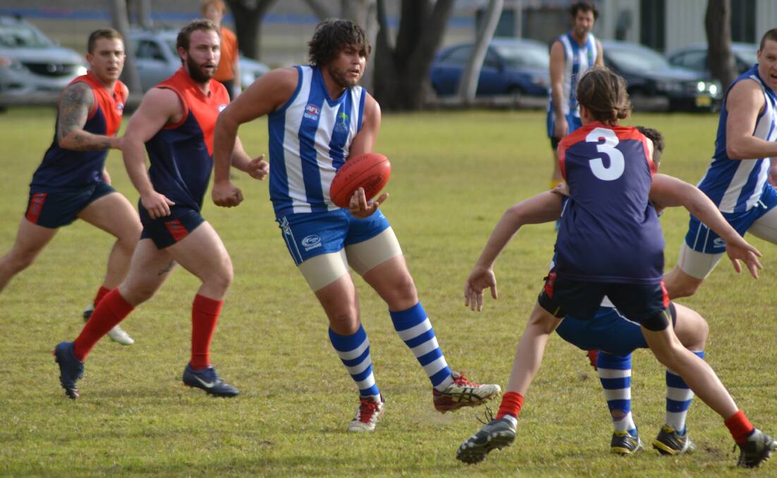 OUTNUMBERED: Figtree Kangaroos’ Josh Spicer offloads a pass. 