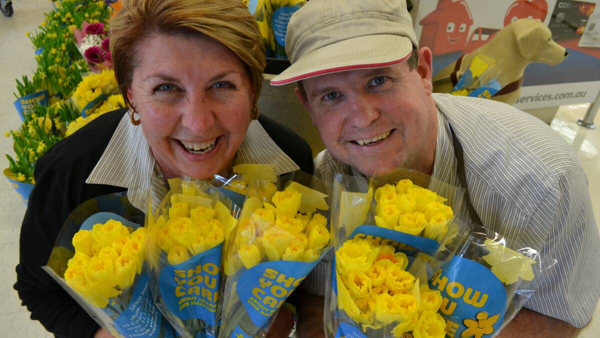 Coles checkout second-in-charge Kerrie-Anne Barnes and fresh produce worker Adrian Armstrong are happy to support Daffodil Day. 