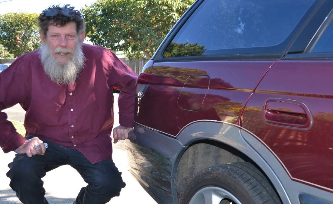 Bomaderry man Mick Marcal inspects the damage to his car after being caught up in a high speed police chase last Thursday.