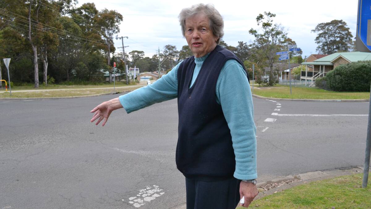 Kirsten Hodges points to a spot on the busy intersection where a local resident was run over and seriously injured. 