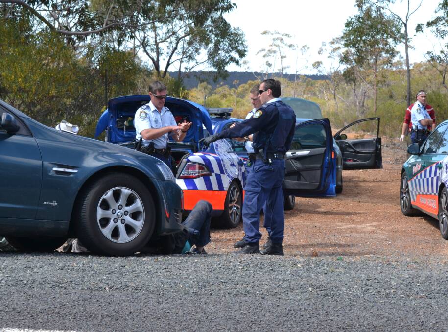 Police officers with three men arrested after a wild pursuit from Berry to Yerriyong on Thursday.