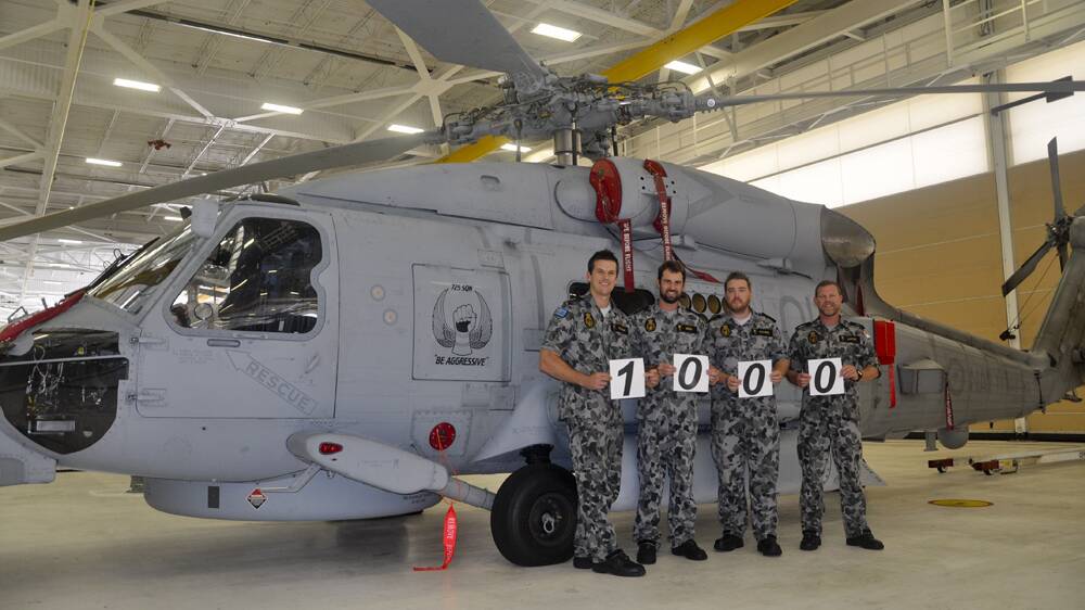 Petty Officer Matt Polman, Leading Seaman Keith Eddy, Petty Officer Luke Stevens and Leading Seaman Courtnay Roper in front of a MH-60R Seahawk Romeo, after NUSQN 725 achieved 1000 flight hours during training in Jacksonville, Florida.