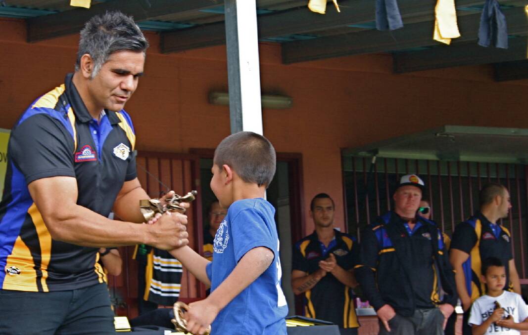 BENNY AND THE JETS: Nowra-Bomaderry Jets captain-coach Ben Wellington congratulates best and fairest under 8 Wallaby Cohen Langlo while his team mates look on. 