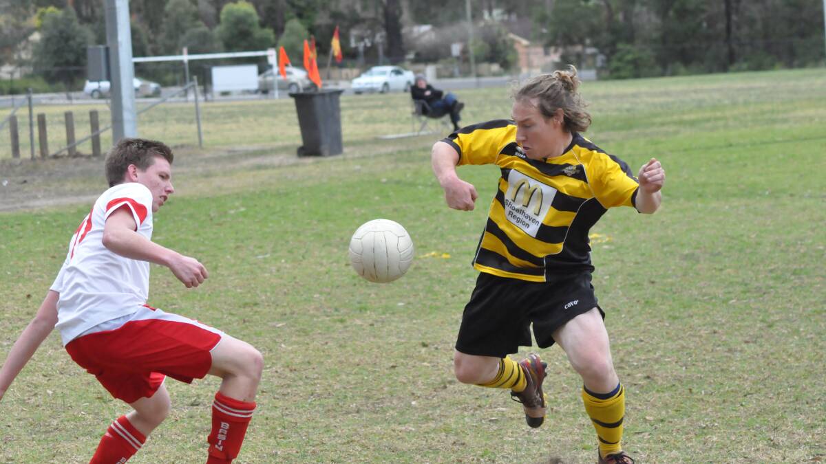 STILL FIGHTING: St Georges Basin’s Tim Shields and Carik Taylor from Bomaderry fight for the ball during Saturday’s clash, which Bomaderry won 5-nil. Photo: PATRICK FAHY  